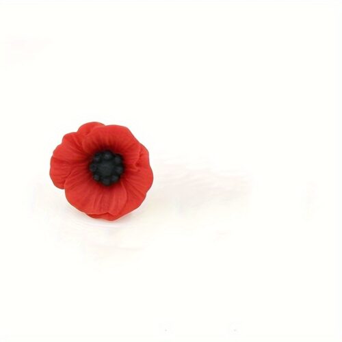 A red poppy lapel pin with intricate petal detailing, symbolizing pride. The pin can be worn on a lapel, hat, tie, or as a brooch. It represents remembrance and support, often associated with veterans.